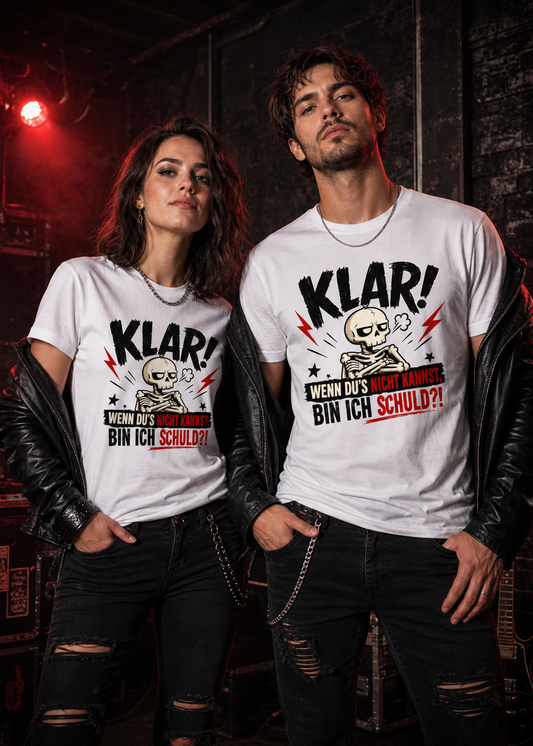 Frau und Mann im rockigen Stil tragen weiße Unisex T-Shirts mit Skelett-Motiv und dem Spruch „Klar! Wenn du’s nicht kannst, bin ich schuld?!“.